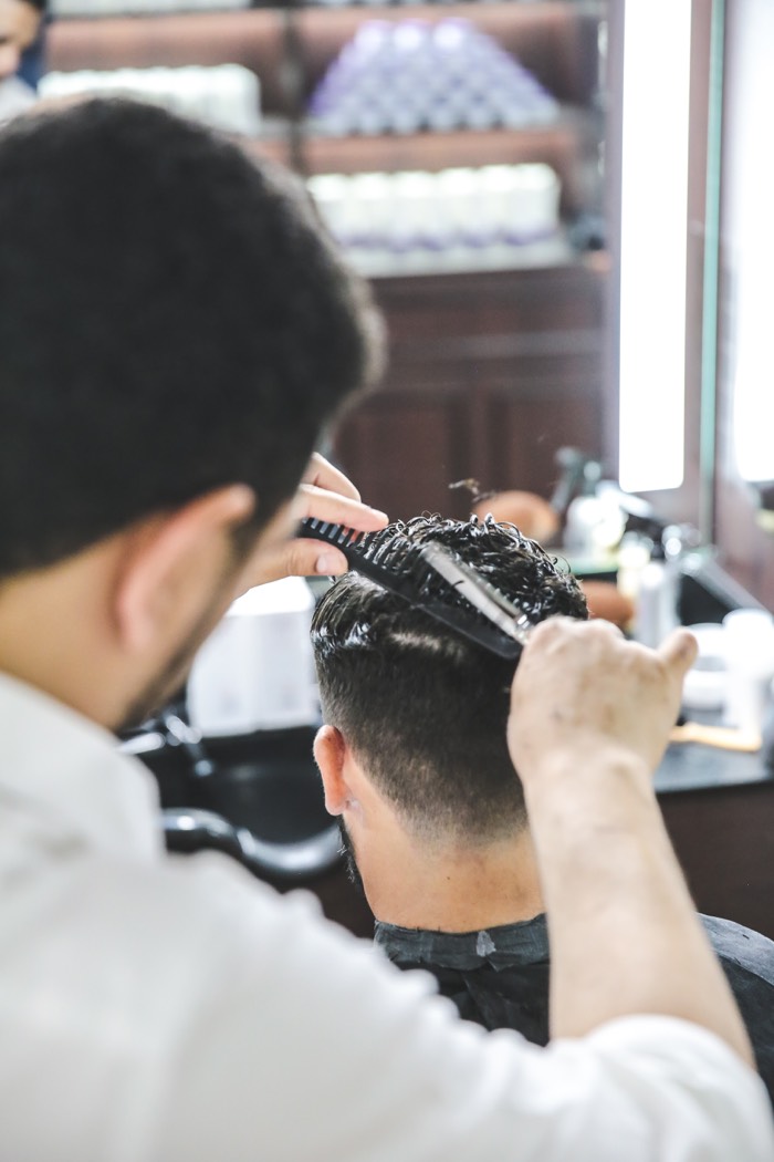 Clippers blending a fade at the back of the head, The British Barbers