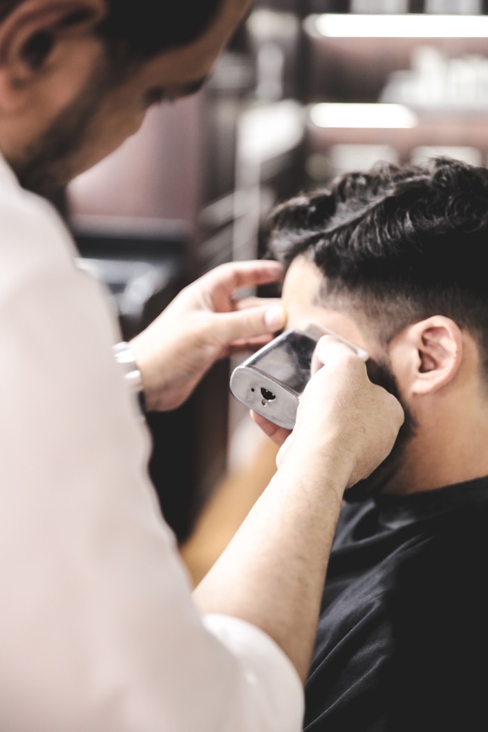 Detailing the edge of a fade with clippers, The British Barbers Chinatown