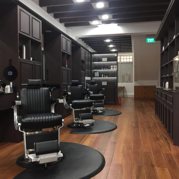 Interior of The British Barbers premium barbershop in Chinatown Singapore – classic gentleman grooming space with leather chairs and elegant design