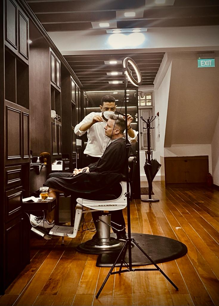 Interior of The British Barbers premium barbershop in Chinatown Singapore – classic gentleman grooming space with leather chairs and elegant design